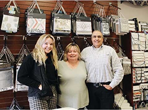 A small family standing together in the store interior